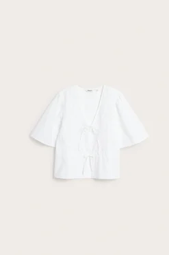 Blus i bomullspoplin med broderi och knytband