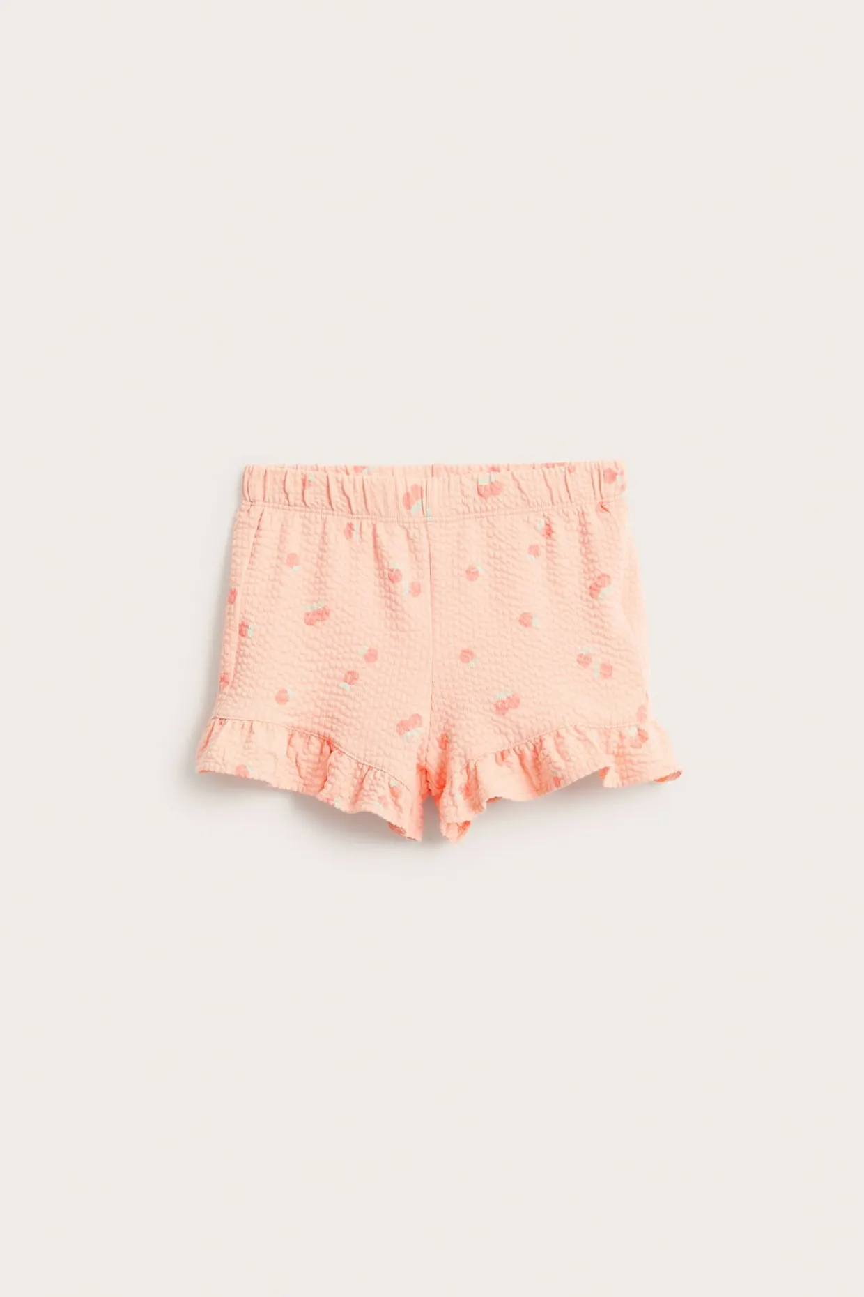 Shorts med persikomönster och volangkant