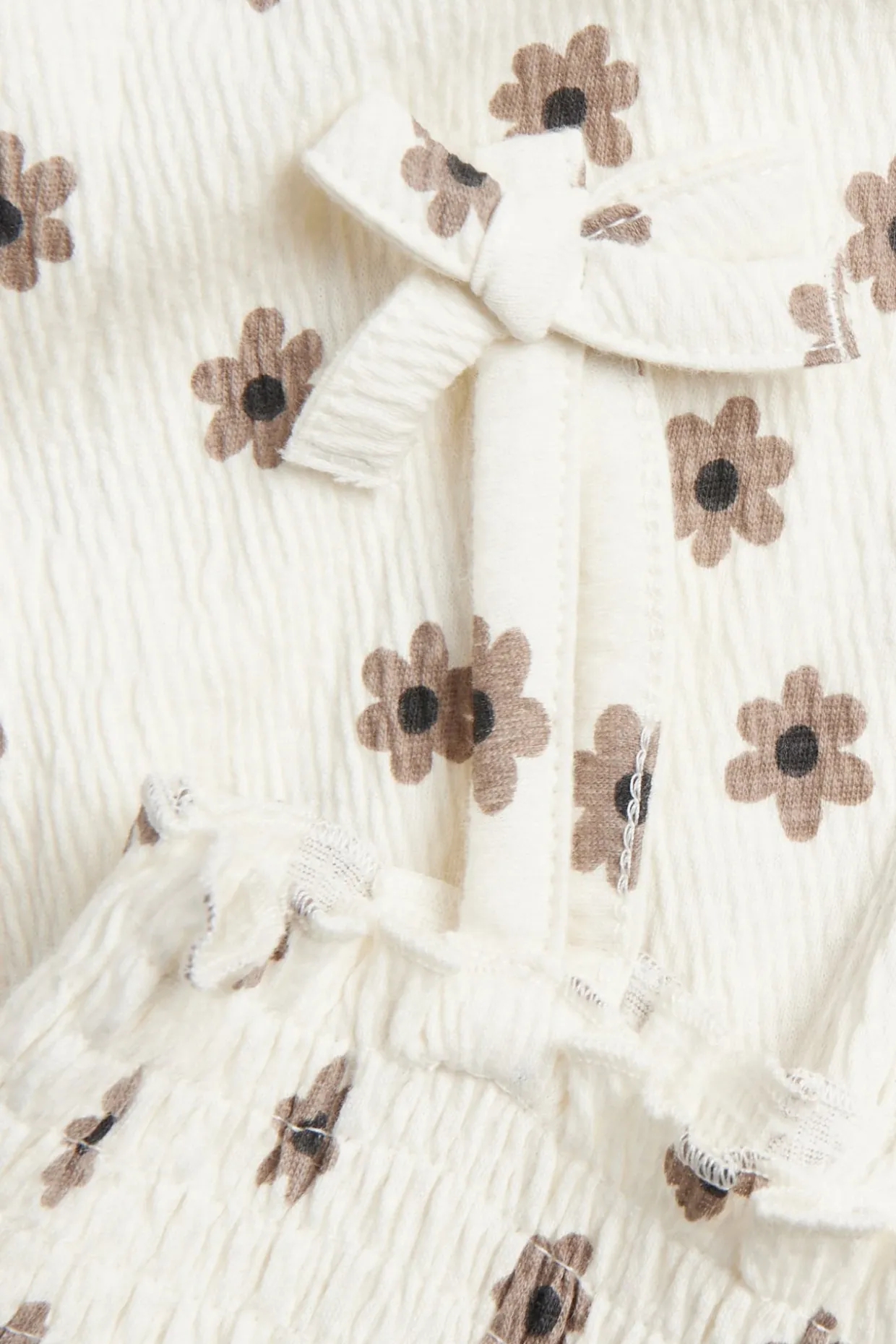 Småblommig jumpsuit med rosetter