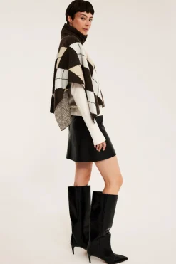 Stickad poncho med polokrage och rutmönster